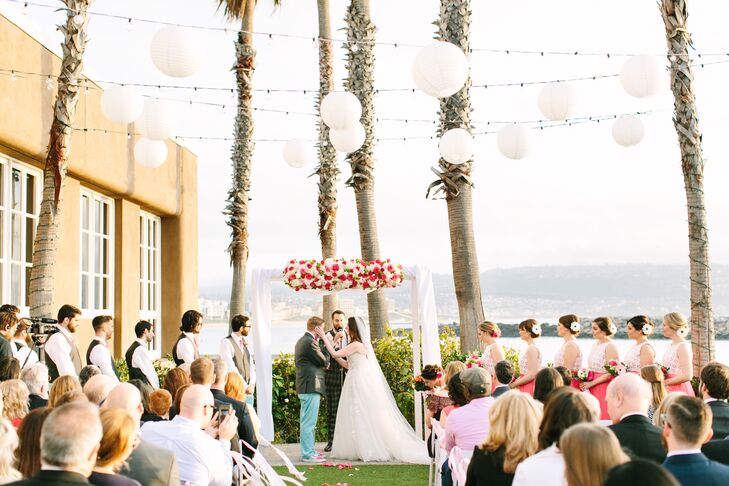 Amanda and Thadd said their vows outside under a colorful floral wedding arch made by Kathy Buffandeau.