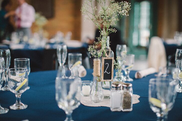 Baby's breath was placed in glass bottles of varying heights to create these simple centerpieces.