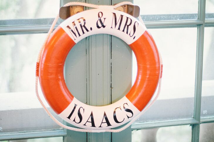 The couple scattered nautical-themed props throughout their reception – including a boat wheel and this personalized life preserver.