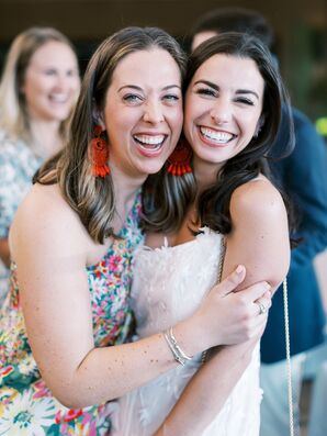 Friend With Orange Drop Earrings Embracing Bride at Italian-Themed Rehearsal Dinner