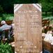 Instead of paper programs, Gina and Mike opted for something more fitting for their bohemian style: listing each member of their wedding party in white on an wooden sign. The note also included their hashtag for anyone who wanted to post photos on social media.