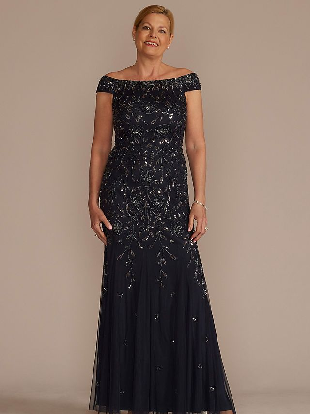 A model shows off this scoop-neck mother of the bride gown with metallic embroidery.