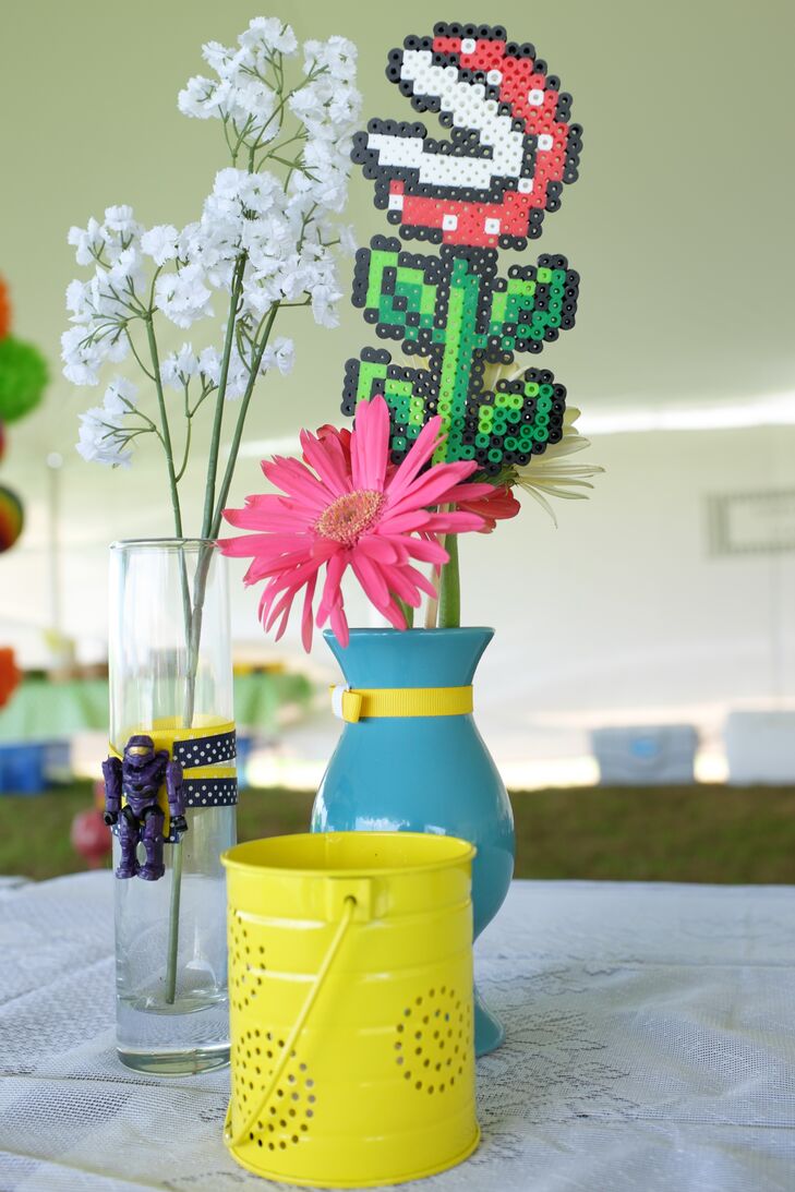 Fresh pink gerbera daisies were displayed next to perler piranha plants for the colorful, geeky centerpiece decor.