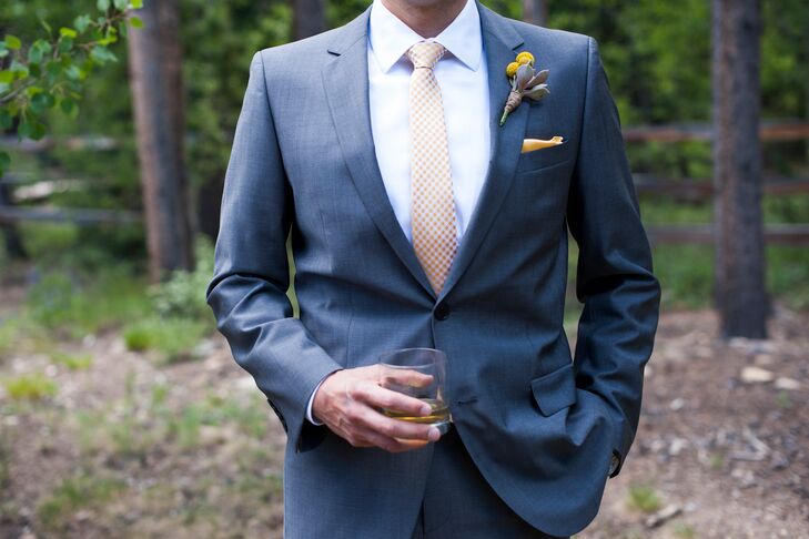 Phil wore a Hugo Boss Red Label Suit with a yellow pocket square to match the wedding colors.