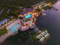Bungalows Key Largo aerial resort view blue umbrellas and lit pool at sunset