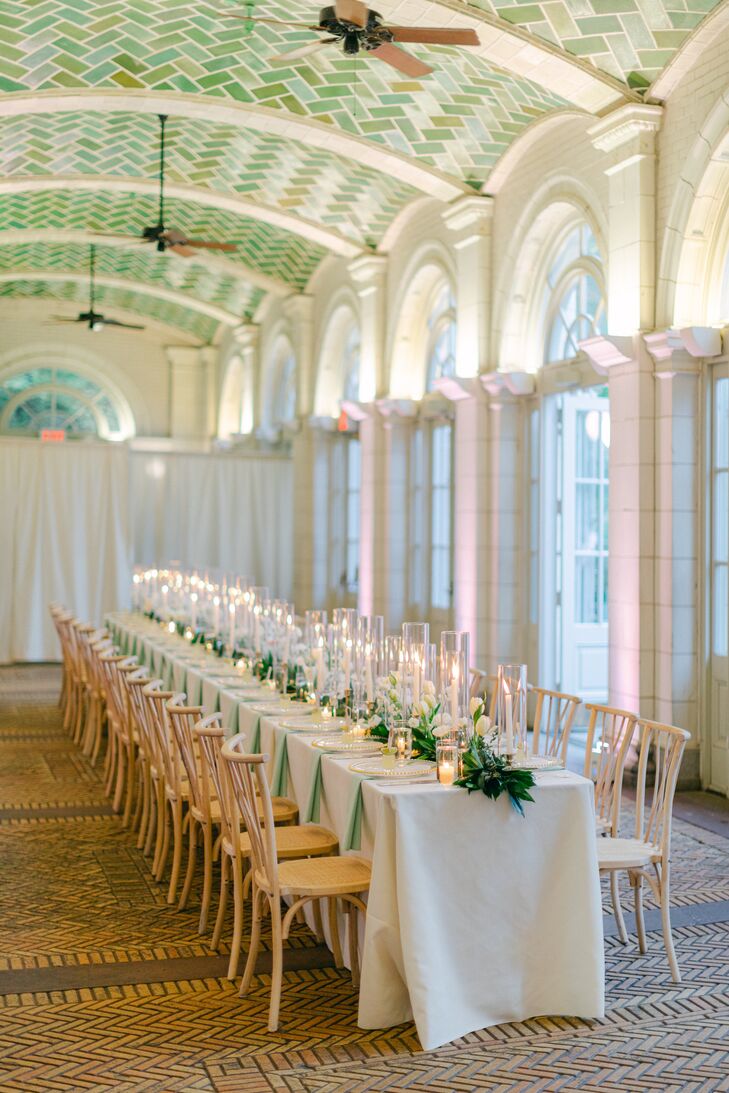 Long Reception Table in the Boathouse With White Linen, Simple Greenery Runner, Taper Candles and Low Candles