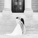 Newlyweds Kiss on the Steps of a Museum