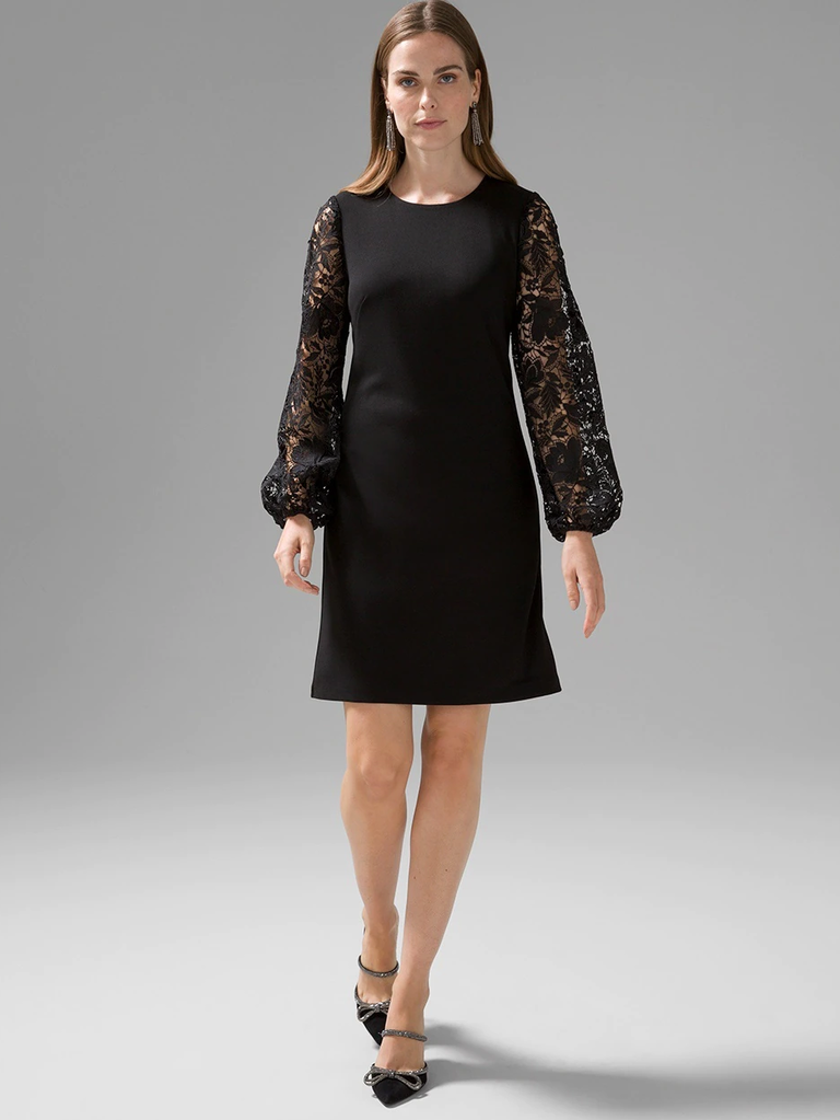 A model shows off a little black dress with wrist-length lace sleeves.