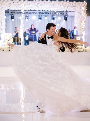 Groom Spins Bride in Ballgown Around on a White Dance Floor
