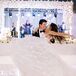 Groom Spins Bride in Ballgown Around on a White Dance Floor