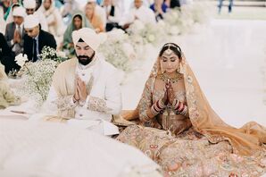 Sikh Bride and Groom During Prayer at Religious Ceremony, White and Gold Fashion, Achkin and Lengha Outfits