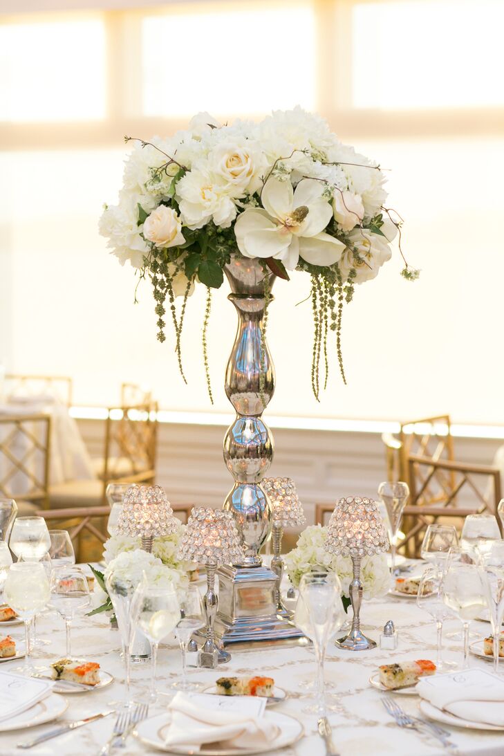 Tall arrangements of white orchids, roses and hanging amaranthus topped the round tables at the reception.