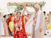 Indian bride and groom in traditional wedding clothes during recessional