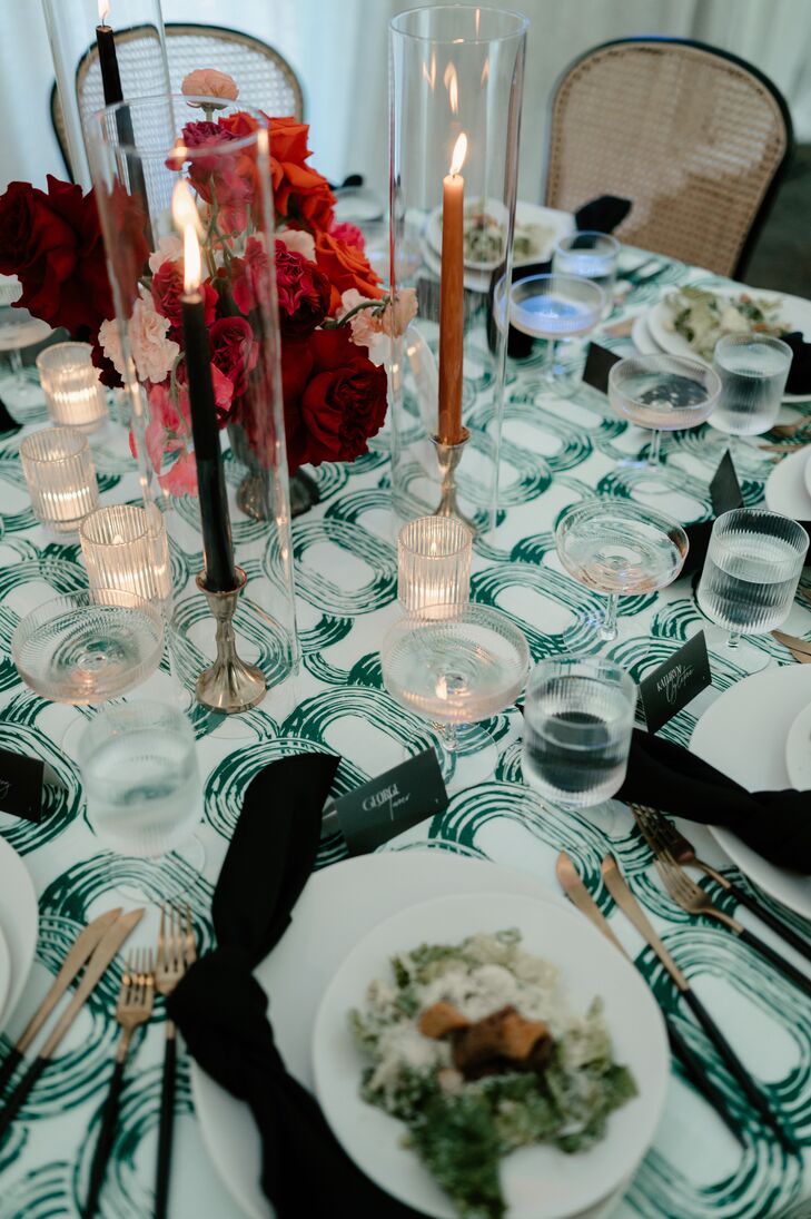 Wedding Reception Tablescape With Patterned Linens and Colored Taper Candles