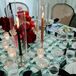 Wedding Reception Tablescape With Patterned Linens and Colored Taper Candles