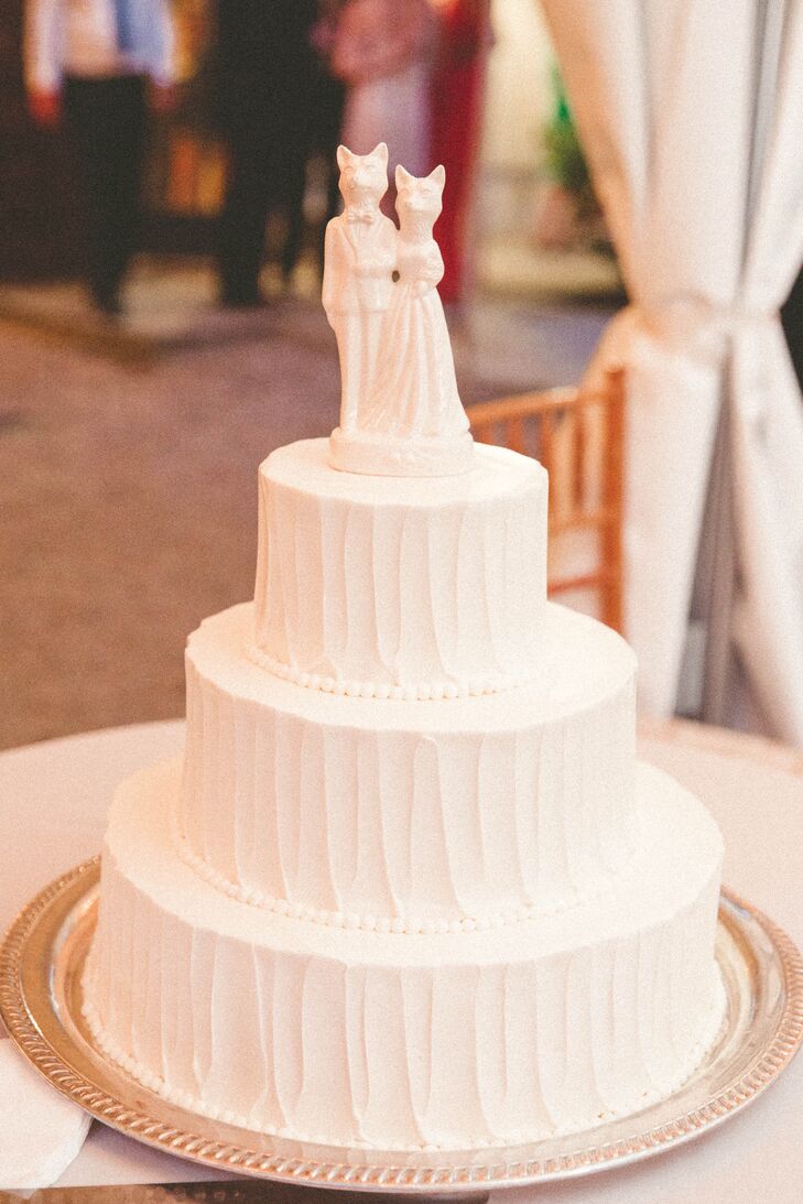 Bringing some extra flair to the mix, Lauren and Paul used small fox accents throughout the wedding. Their cake was no exception. Textured, white buttercream frosting covered all three round layers. A whimsical figurine of two foxes in formal attire topped the confection for an unexpected treat—it’s porcelain-like design even had the same hue as the frosting.