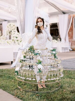 A Woman With a Tiered, Structured Skirt Featuring Champagne and Flowers