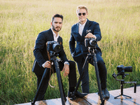Two wedding photographers and videgraphers posing for a pitcture. 