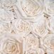 A whimsical paper flower wall with big garden roses served as a backdrop for the wedding cakes and created a focal point for the reception space.