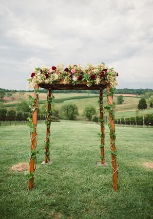 Wood Frame Chuppah with Burgundy and Pink Flowers and Vines