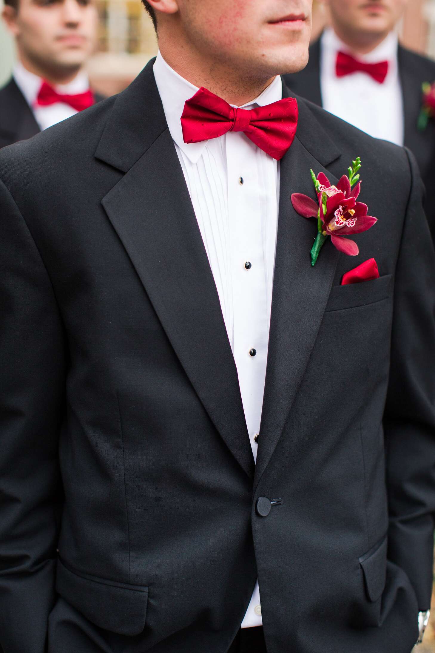 Groomsmen In Black Tuxedos With Red Bow Ties