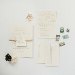 White Wedding Invitations and Paper Goods With Stamps