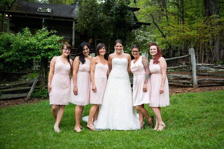 Keeping with the simple wedding styles, Ashley's bridesmaids wore short, blush bridesmaid dresses in various styles of their choosing paired with casual shoes. "We wanted the wedding party to be comfortable in their outfits for the day and show off their individual styles," Ashley says.