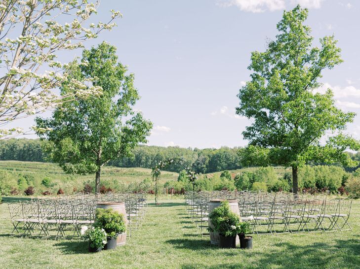 Garden Wedding Ceremony Setup With Wrought Iron Chairs