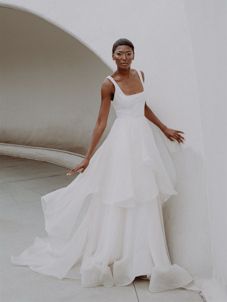 Model wears a classic white wedding dress by Loulette. 