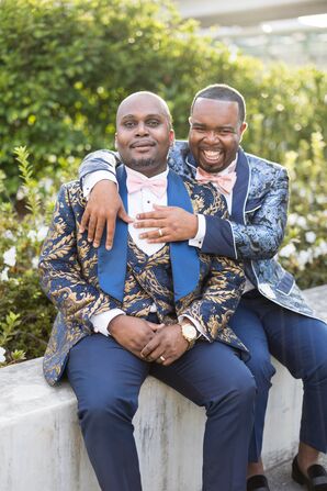 Grooms Posing for Wedding Portraits in Ornate Blue-and-Gold Brocade Tuxedos