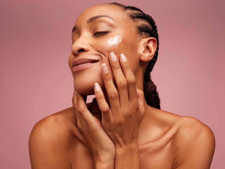 woman with retinol on face