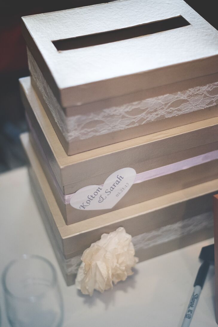 Stacks of brown boxes wrapped with peach and pink ribbon served as the card box for wedding gifts.