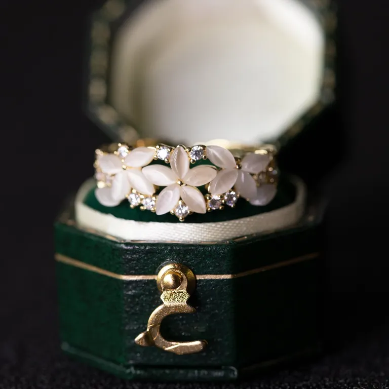 pearly white gemstones in petal design and diamonds