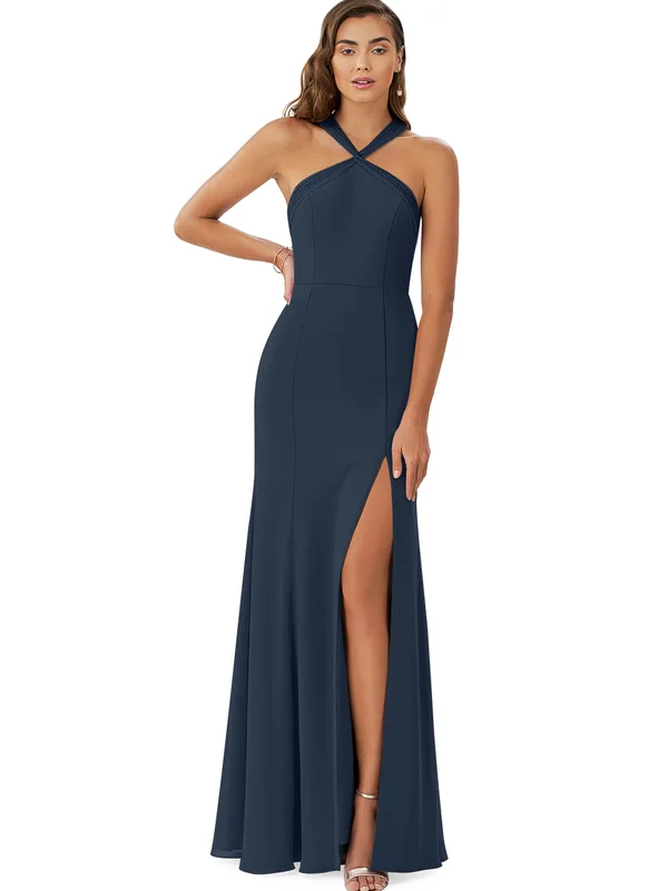 A model wears a halter-neck navy blue bridesmaid dress with a high slit.