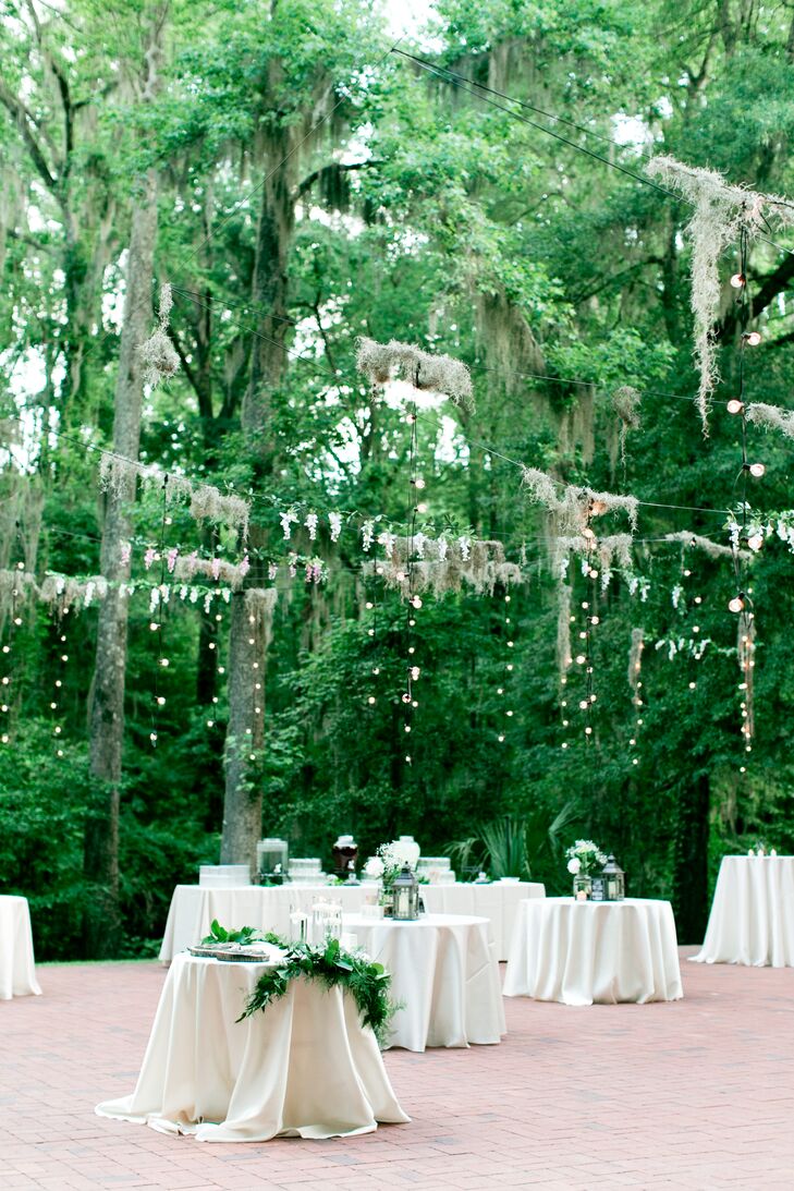 Suspended over the dance floor was a display of twinkle lights draped in Spanish moss and flowers. The handmade installation added a dreamy feel to the reception, and the subdued lighting created the romantic environment Jamie wanted.