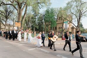 Bride and Groom With Wedding Guests Being Led Down the Street in New Mexico by Mariachi Band