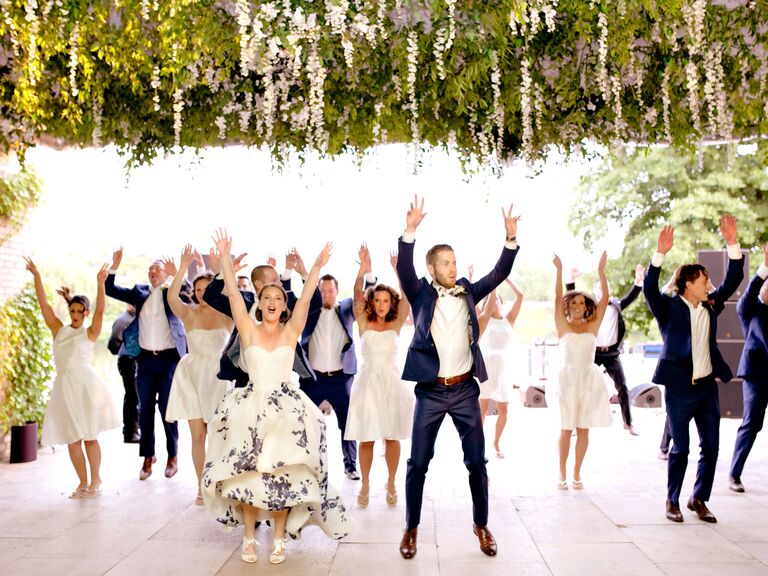Bride and groom dancing with wedding party at the reception.