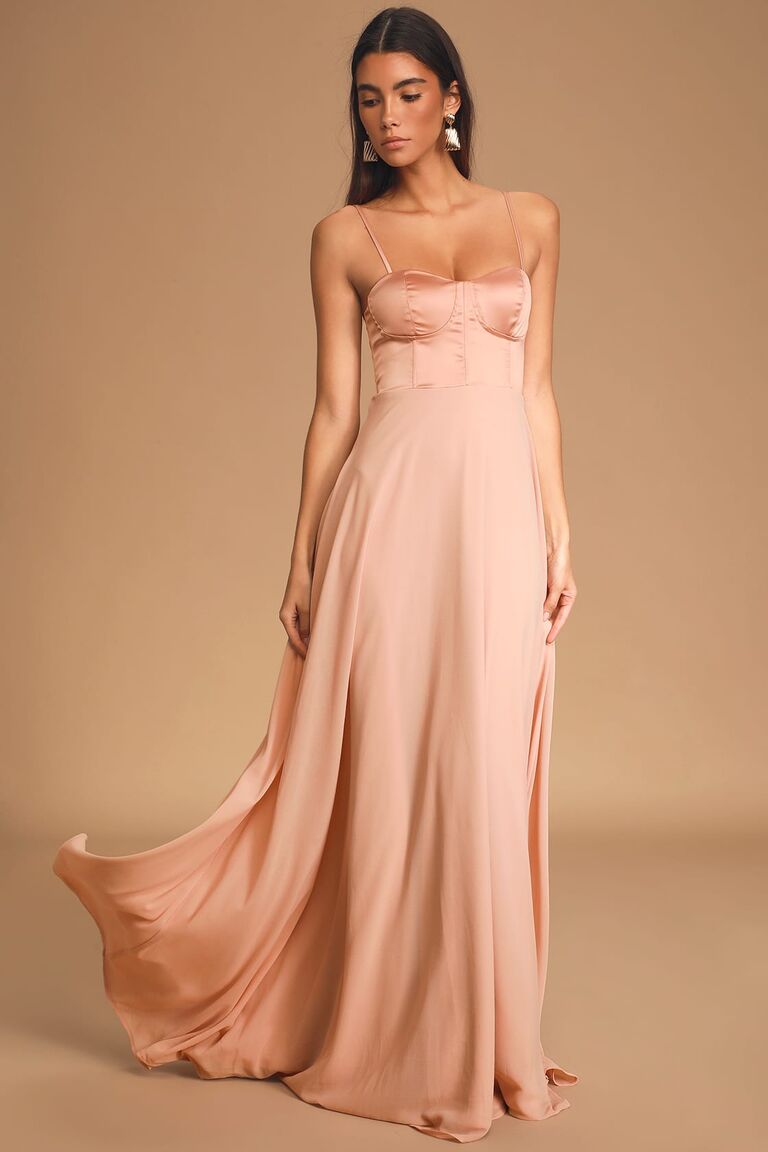 Model wears a blush-pink satin gown. 
