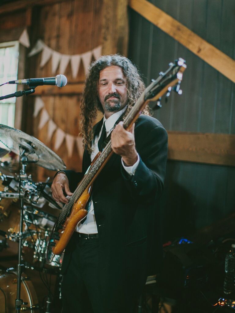 A person playing the bass at a wedding reception. 