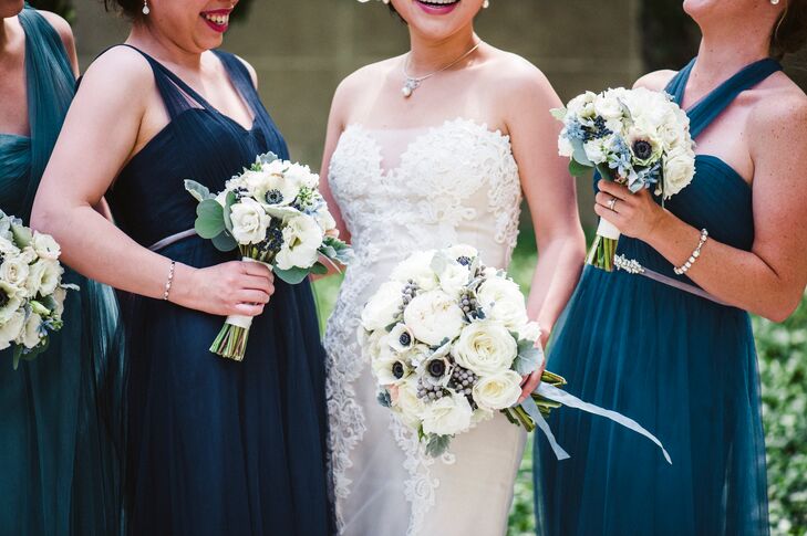 Lydia's bouquet consisted of white garden roses, white ranunculus, white lisianthus and white anemones accented with silver brunia berries, light blue delphinium and silvery dusty miller leaves. Stems were wrapped in blue silk ribbon. The bridesmaids carried petite bouquets of white lisianthus, white anemones, white majolica and blue viburnum berries accented with dusty miller.