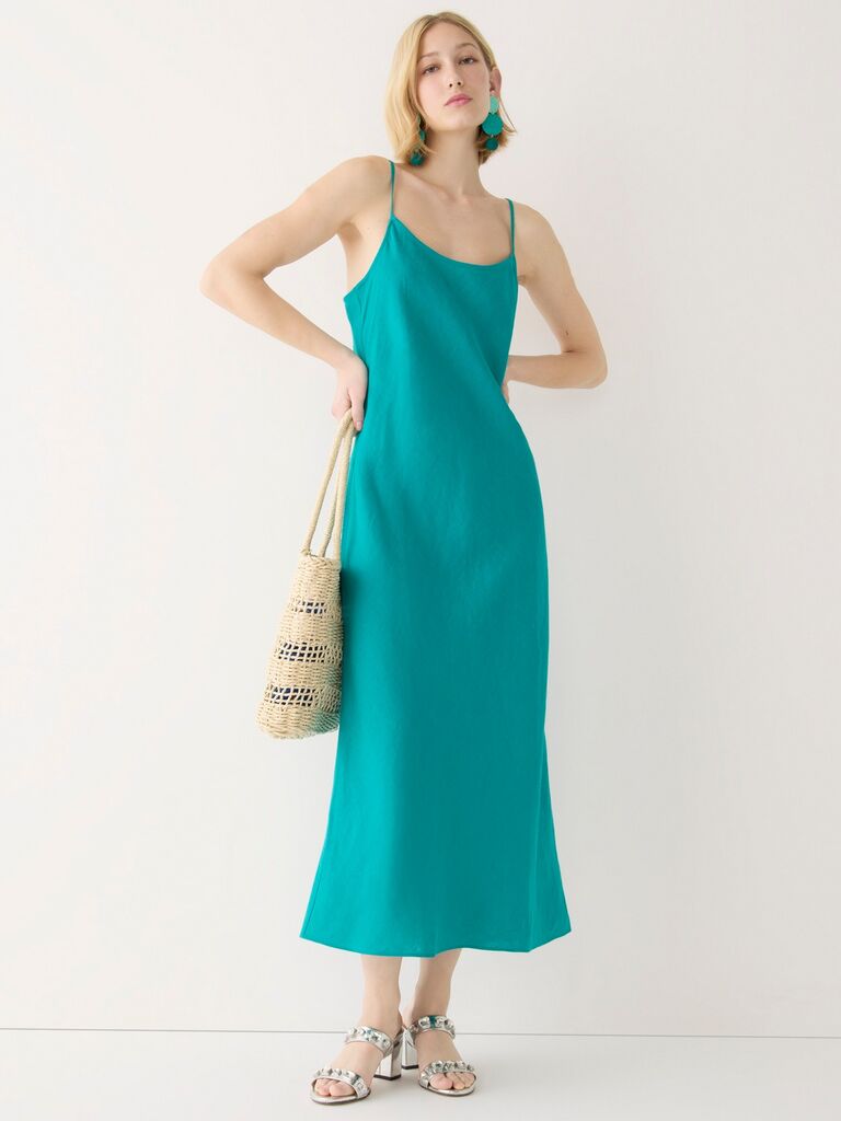 Model wears a semi-formal teal blue slip dress. 