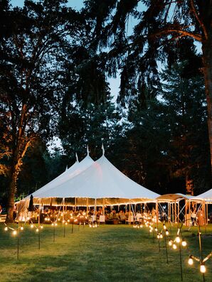 Lit String Lights Leading to Tented Summer Reception in the Evening