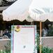 Rehearsal Dinner Welcome Sign With Lemon, Blue Patterns, Flower Designs and a Parasol