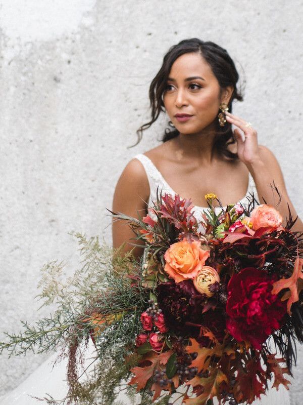 Bride holding large red bouquet