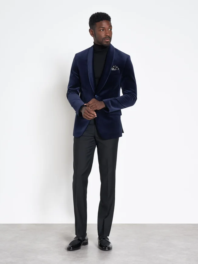 A model wears this elegant navy blue wedding jacket.