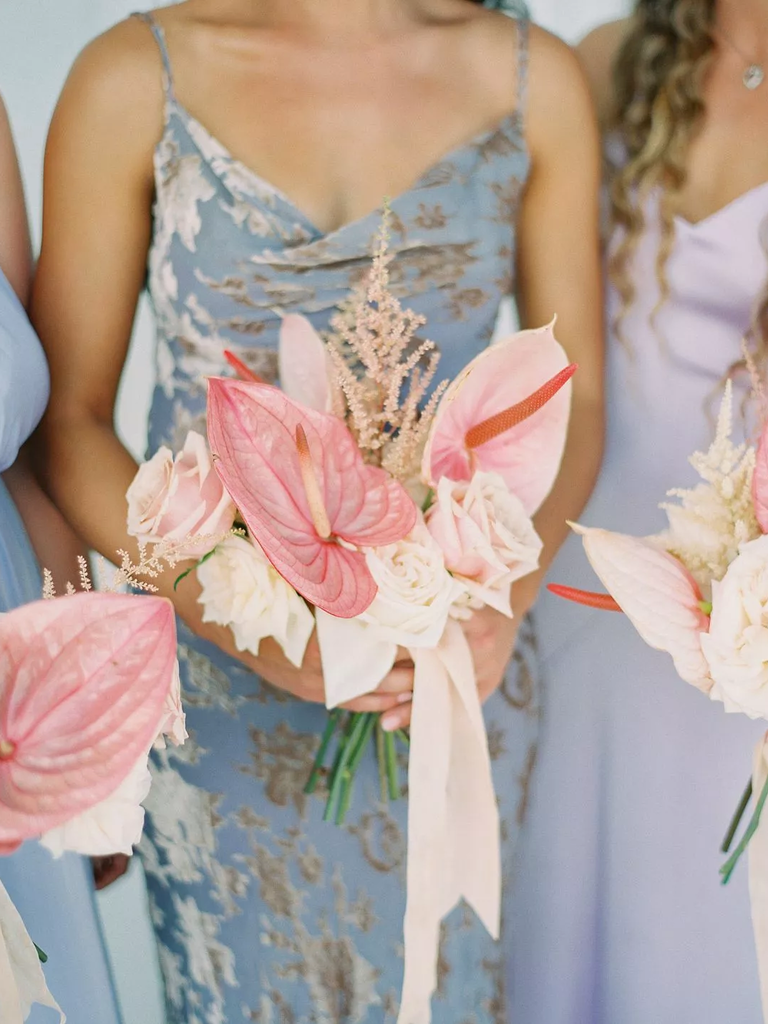 These pale pink bouquets match perfectly with dusky blue bridesmaid gowns.