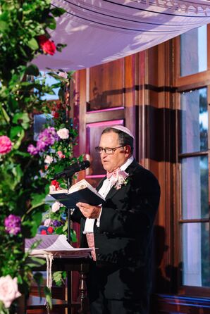 Groom's Father, a Rabbi, Wearing Pink and Purple Accessories, Reading From the Torah Under Chuppah at Ceremony