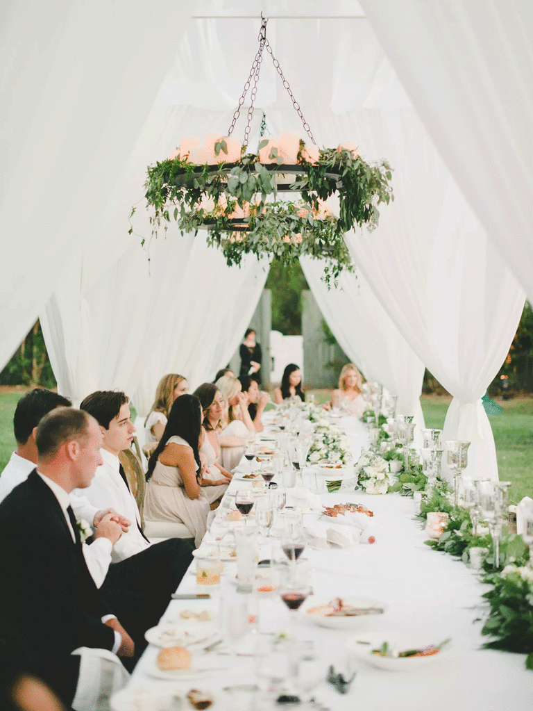 Romantic wedding head table at an outdoor wedding reception. 