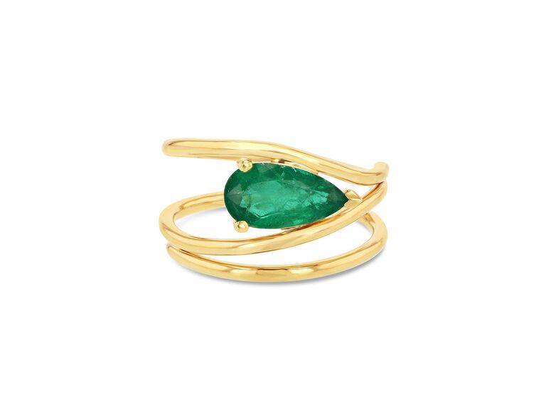 Emerald engagement ring with a gold band by Grace Lee. 