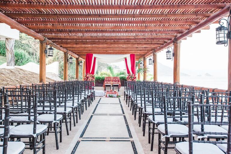Fabric mandap and black Chiavari chairs on open-air terrace
